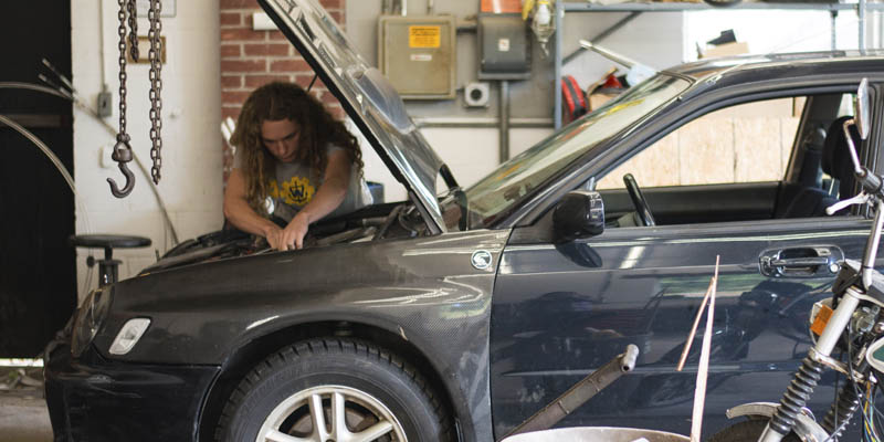 Webb student working on his car