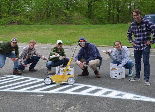 Students spray painting lines in the parking lot on Webb Institute's Founder's Day.