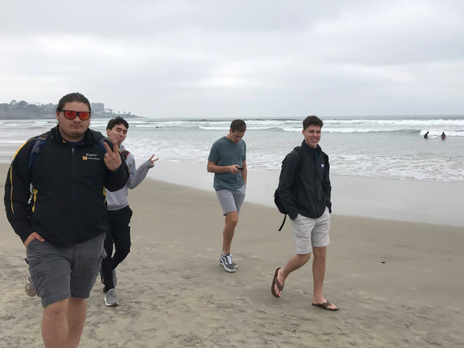 Students walking along the beachshore during Winter Work Term in San Diego