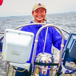 Conquering the Open Seas: Mo fearlessly navigates the waves as she commands her boat with skill and determination, conquering whatever challenges the open sea may bring.